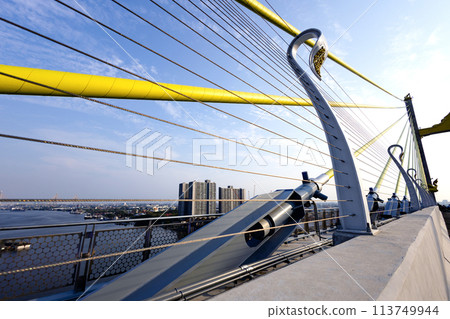 Yellow Cables On A Suspension Bridge Against Blue Sky In Bangkok. Yellow Cables On A Suspension Bridge Against Blue Sky In Bangkok. 113749944