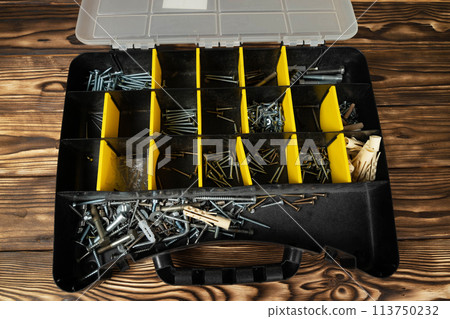 Toolbox Filled With Screws and Nails 113750232
