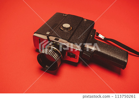 vintage portable movie camera on a red background. retro, 70s, 80s 113750261