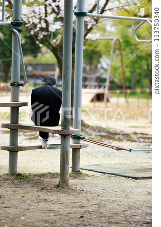 A student who doesn't go to school killing time in the park A student who doesn't go to school killing time in the park 113750340