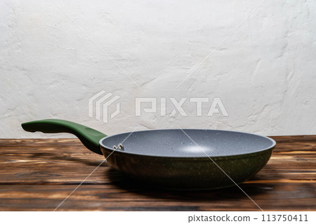 Frying Pan on Wooden Table. ready for cooking or serving food 113750411