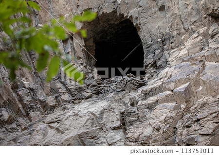 A hole in the bedrock wall resembles a cave. Ashabi-Kahf in Nakhchivan. A hole in the bedrock wall resembles a cave. Ashabi-Kahf in Nakhchivan. 113751011