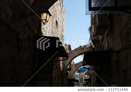 A narrow street among stone houses in old Jerusalem, Israel. 113751440