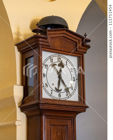 brown wood retro floor clock against the wall 113751454