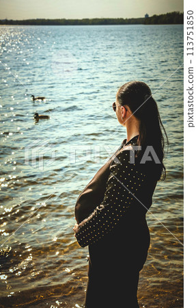 Pregnant girl with glasses on the background of the sea Pregnant girl with glasses on the background of the sea 113751850