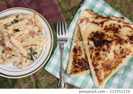 Plate of Pasta Carbonara With Italian Flat Bread on Rustic Table Plate of Pasta Carbonara With Italian Flat Bread on Rustic Table 113752159