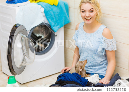 Woman sorting clothes for washing Woman sorting clothes for washing 113752258