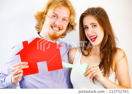 Couple holding real estate paper symbols 113752761