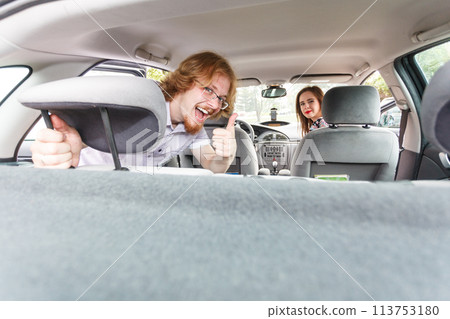 Happy man and woman in car 113753180