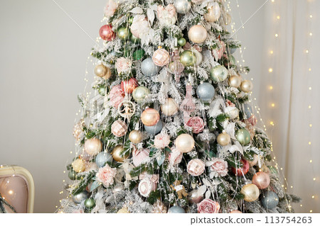 Christmas tree decorated with bright garlands and shiny balls 113754263