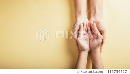 Top view of family hands stacked isolated background. Parents and kid hold empty space a gesture of support and love on Family and Parents Day. Concept of togetherness and trust. 113754517