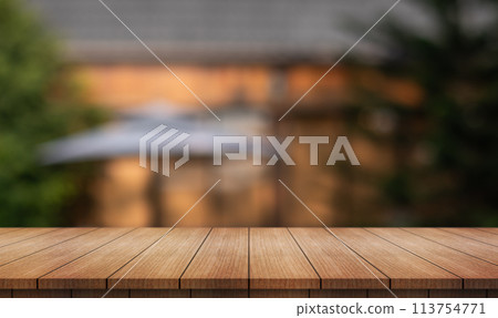 Empty wooden table top with lights bokeh on blur restaurant background. 113754771