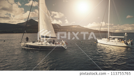 Brodick Harbour, Arran Island, Scotland. Luxury yachts at sun shine regatta aerial. Sailing in wind at open sea. Epic seascape of ocean bay. Summer cruise on boats. Cinematic drone shot Brodick Harbour, Arran Island, Scotland. Luxury yachts at sun shine regatta aerial. Sailing in wind at open sea. Epic seascape of ocean bay. Summer cruise on boats. Cinematic drone shot 113755765