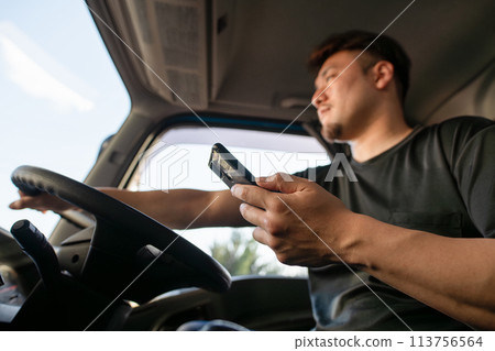 卡車司機一邊駕駛一邊操作智慧型手機 113756564