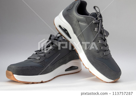 Pairs of Gray sports sneakers on white background Pairs of Gray sports sneakers on white background 113757287