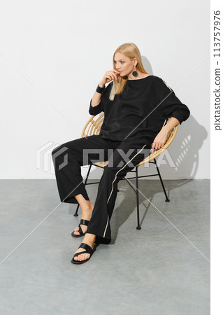 Dreamy woman in black home clothes 113757976