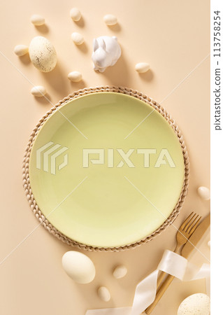 Easter table setting background green white plate, cookies, eggs and bunny. Easter table setting background green white plate, cookies, eggs and bunny. 113758254