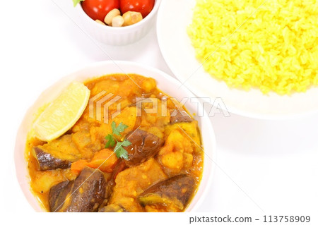 Nepalese eggplant and potato dry curry on a light background Nepalese eggplant and potato dry curry on a light background 113758909