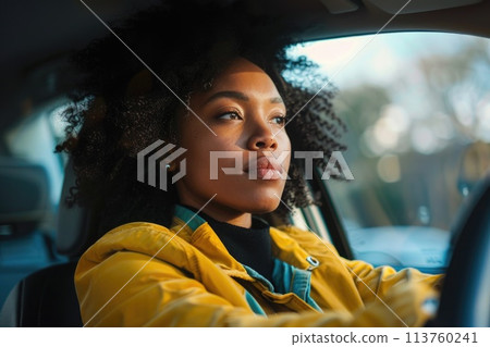 Elegant woman driving a car, exuding confidence and independence with a strong, focused gaze 113760241