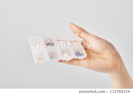 Tablets in pill case 113760354