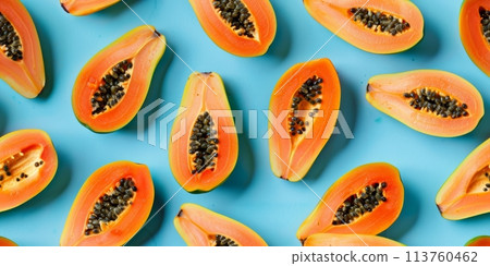 Slices of papaya on blue background 113760462