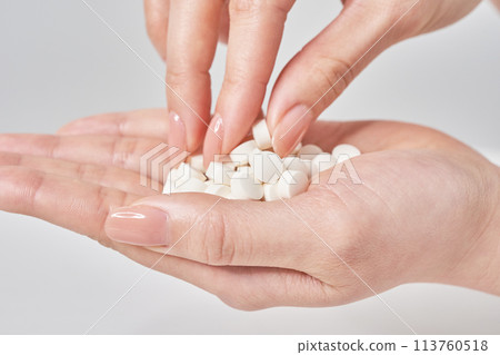Many pills in the palm of a hand Many pills in the palm of a hand 113760518