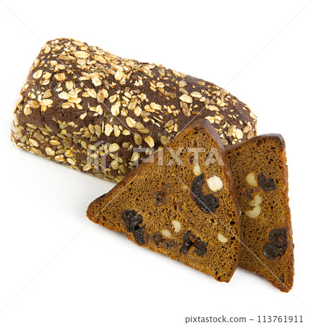 Homemade bread with dried fruits, raisins, prunes, hazelnuts and walnuts isolated on a white background. 113761911