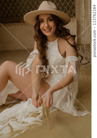 Beautiful girl posing in a boho style wedding dress 113762164
