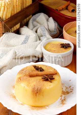 Curau, cream of corn sweet and dessert typical of the Brazilian cuisine, placed in ceramic bowl on wooden table. 113762970