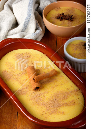 Curau, cream of corn sweet and dessert typical of the Brazilian cuisine, placed in ceramic bowl on wooden table. 113762975