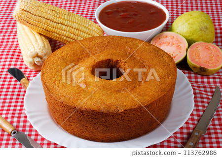 corn cake on white plate on rustic wooden table. Typical Brazilian party food. 113762986