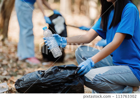 Group of volunteers, community members cleaning the nature from garbage and plastic waste to send it for recycling 113763302