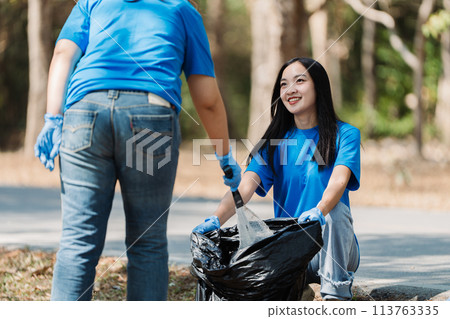 Group of volunteers, community members cleaning the nature from garbage and plastic waste to send it for recycling 113763335