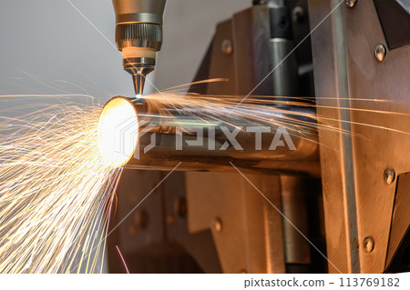 Close up scene the fiber laser cutting machine cut the stainless steel tube and sparkling light. Close up scene the fiber laser cutting machine cut the stainless steel tube and sparkling light. 113769182