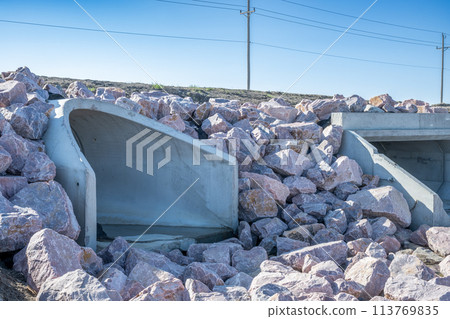 A Bunch of Rocks Next to a Road culvert. A Bunch of Rocks Next to a Road culvert. 113769835