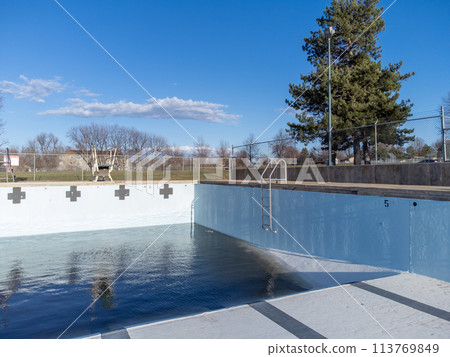inside an empty and drained winterized swimming pool  113769849