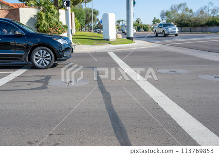 Selective focus on vehicle stopped in the crosswalk.  113769853