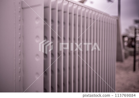 Selective focus on an electric transformer outside a commercial building. Selective focus on an electric transformer outside a commercial building. 113769884