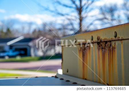 Rusted and peeling paint on an electrical transformer exposed to the elements. Rusted and peeling paint on an electrical transformer exposed to the elements. 113769885