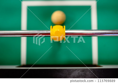 top view on a foosball goalie blocking the ball insider the box top view on a foosball goalie blocking the ball insider the box 113769889