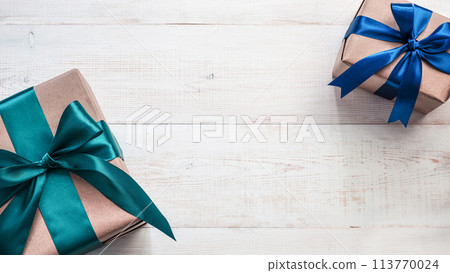 Gift boxes in craft paper and satin ribbon, banner Gift boxes in craft paper and satin ribbon, banner 113770024