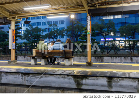 Passengers waiting for the train on the platform at night Passengers waiting for the train on the platform at night 113770029