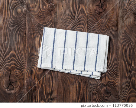 linen napkin on wooden table, top view, mock up 113770056