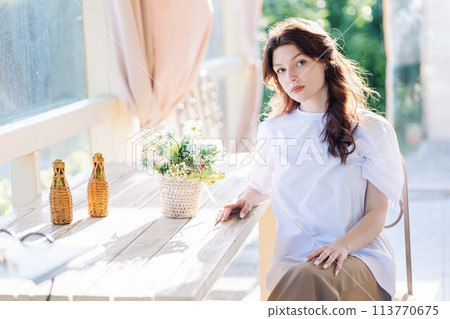 Portrait of a Russian young girl sitting on a chair. Portrait of a Russian young girl sitting on a chair. 113770675