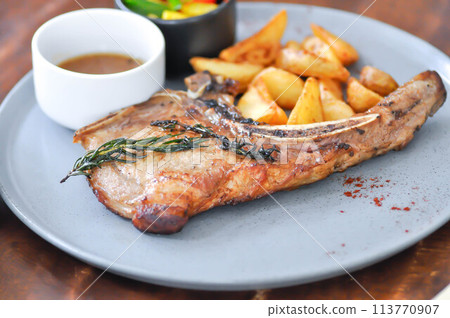 pork chop or grilled pork with French fries and salad pork chop or grilled pork with French fries and salad 113770907