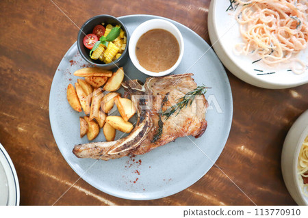 pork chop or grilled pork with French fries and salad pork chop or grilled pork with French fries and salad 113770910