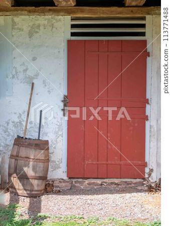 Red antique divided dutch door on colonial barn Red antique divided dutch door on colonial barn 113771488