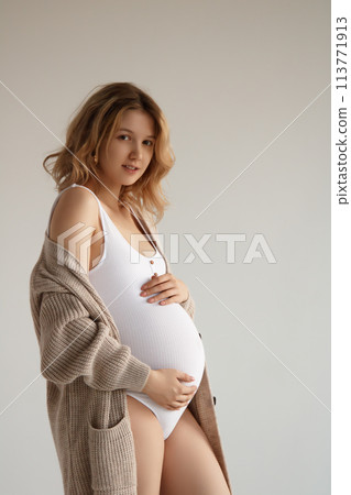 A beautiful pregnant girl in a white bodysuit and A beautiful pregnant girl in a white bodysuit and 113771913