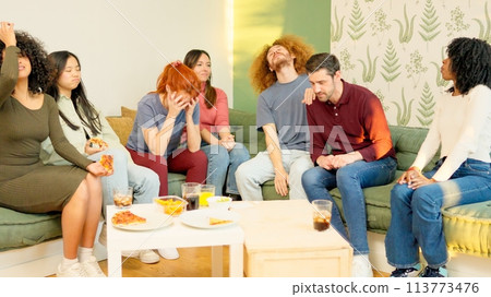 Friends witnessing the end of a match, their team losing 113773476