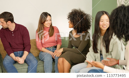 Multi-ethnic friends chatting and smiling at home Multi-ethnic friends chatting and smiling at home 113773495